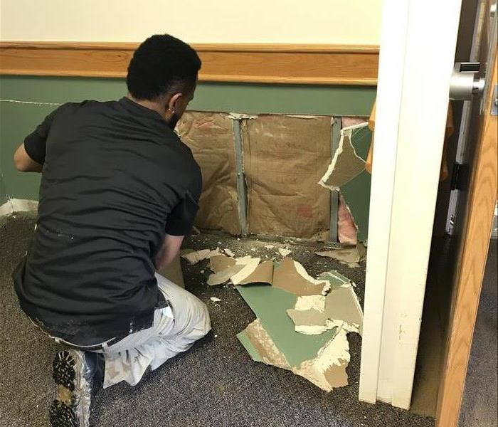 male employee removing sheetrock