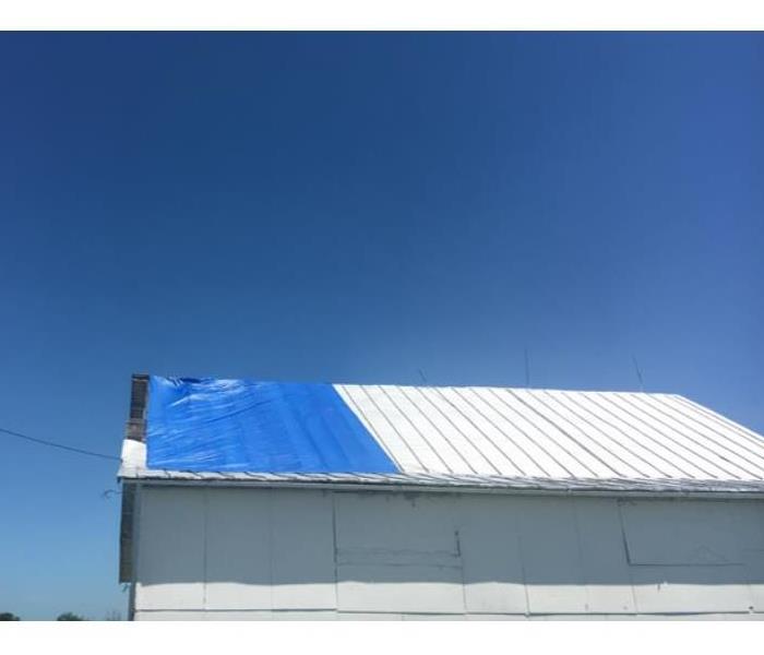blue tarp on barn roof